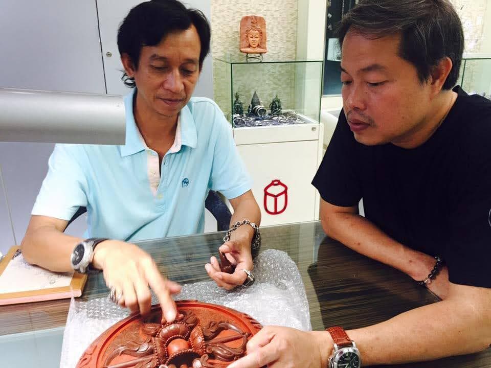 A design consultation over a large carved wax relief at the showroom.